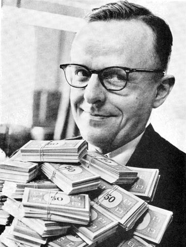 Man holding a pile of Monopoly money.