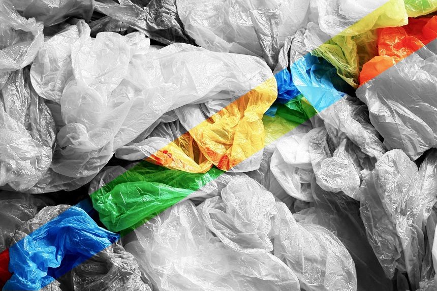 A pile of discarded plastic bags in a grayscale photo. A rainbow color filter is banded over it.
