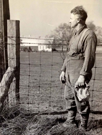 A man named O.W. Collins stands at the mean population center of the United States, near Carlisle, Indiana. 