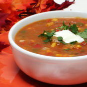 bowl of pumpkin stew with dollop of sour cream