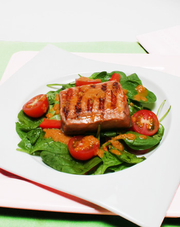 salmon, spinach, tomato salad with ginger and carrot dressing
