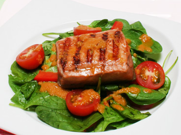 salmon, spinach, tomato salad with ginger and carrot dressing