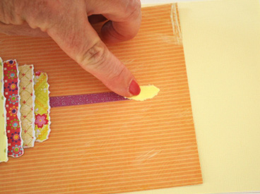 hand gluing paper flame to paper card