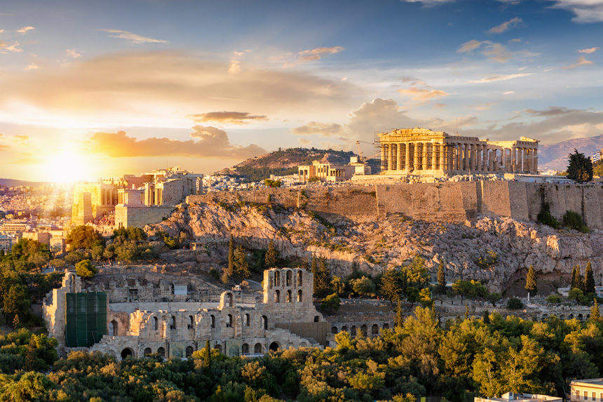 A bright sunset shining on the Parthenon.