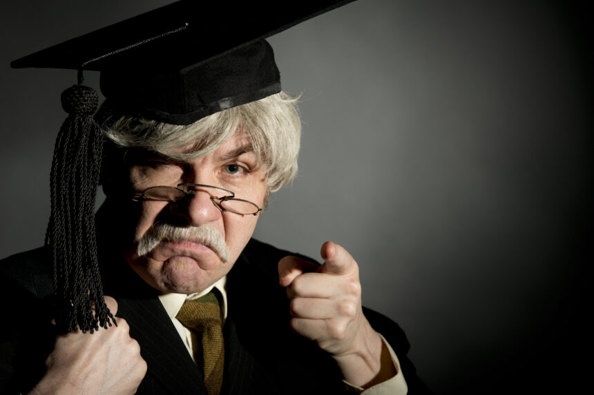 A snooty professor in black robe, mortar board, and pince nez glasses points at you with disdain and disappointment