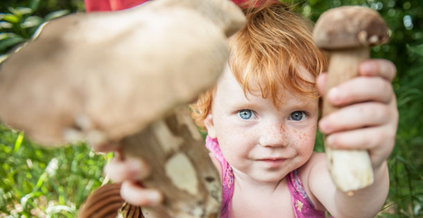 Girl holding large mushrooms