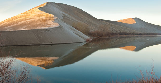 The sand dunes and lake at the Bruneau Sand Dunes State Park at sunrise