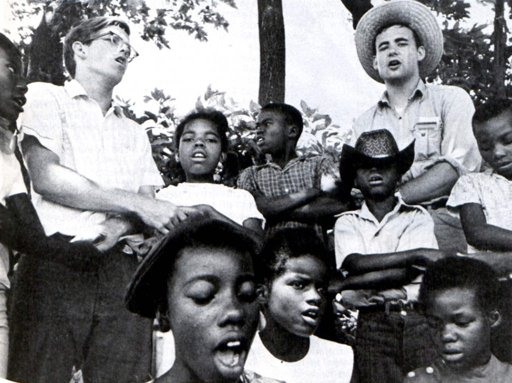 White volunteers sing with Black Americans in Arkansas