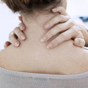 Woman rubbing sore neck