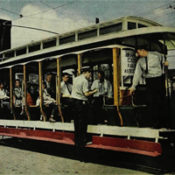 People riding streetcar.