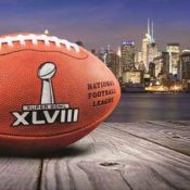 Football with the Super Bowl XVIII logo in front of the New York City skyline