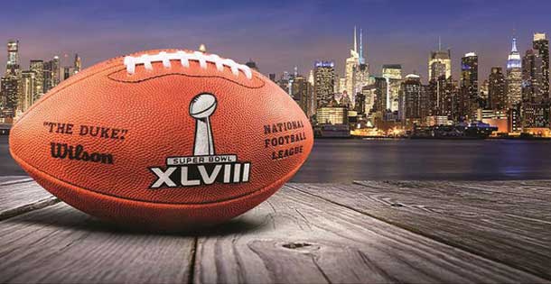 Football with the Super Bowl XVIII logo in front of the New York City skyline