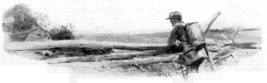 A young man overlooks a field on a hilltopp