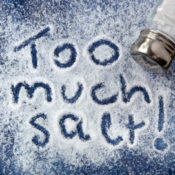 The words "Too much salt!" is spelled out of a pile of salt.