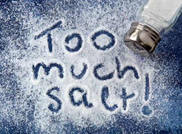 The words "Too much salt!" is spelled out of a pile of salt.