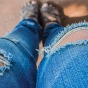 A pair of jeans that are torn at the knees.