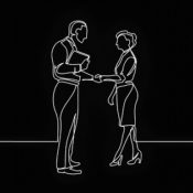 Two people greeting eachother with a handshake