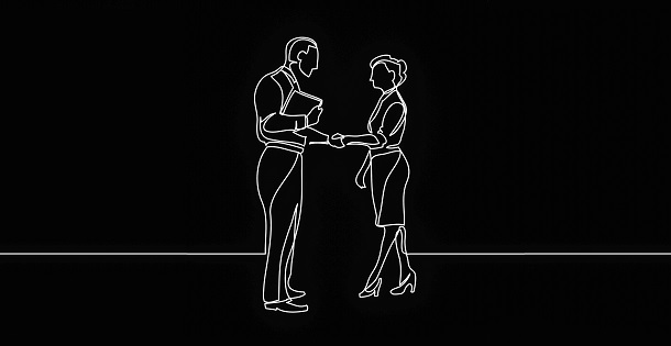 Two people greeting eachother with a handshake