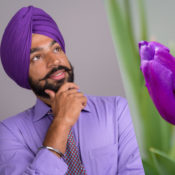 Man wearing a turban and a tulip flower