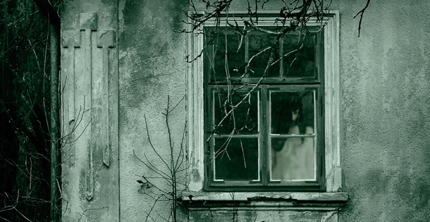 Spooky girl in window